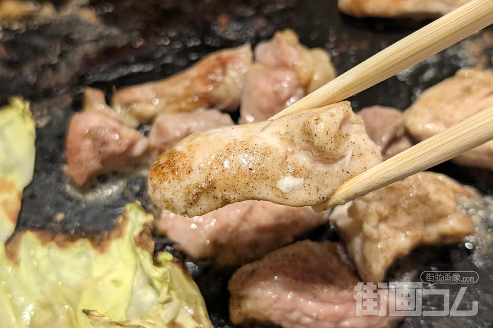 焼けた塩味のむね肉を箸でリフト
