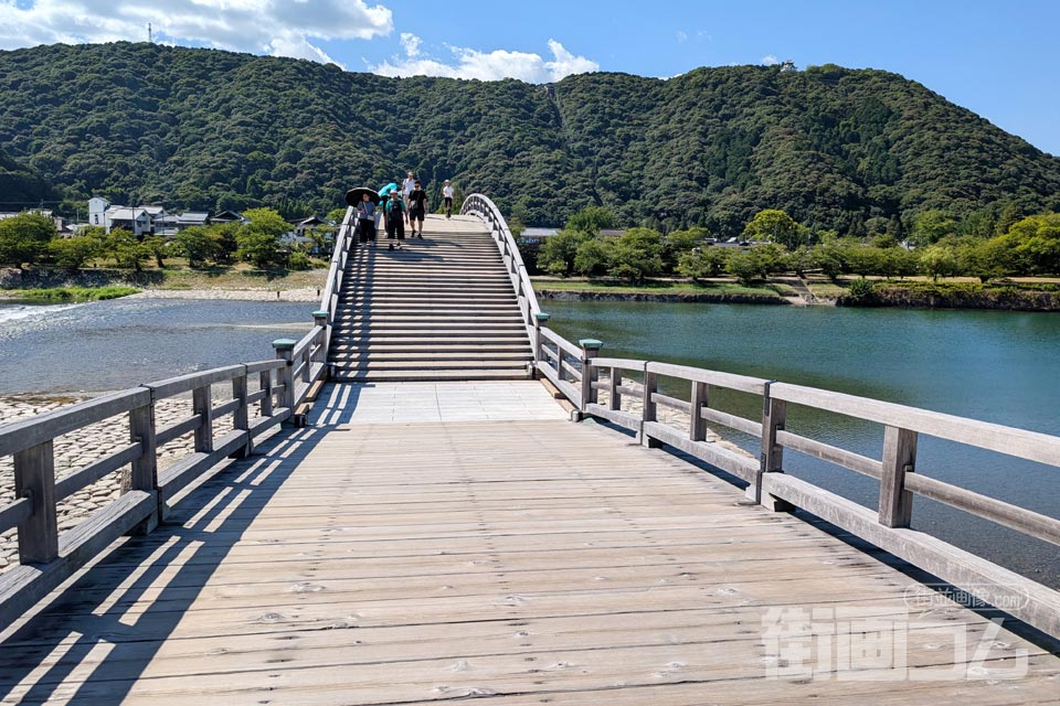 錦帯橋の1つ目の橋の先に反り上がるアーチと山上の岩国城